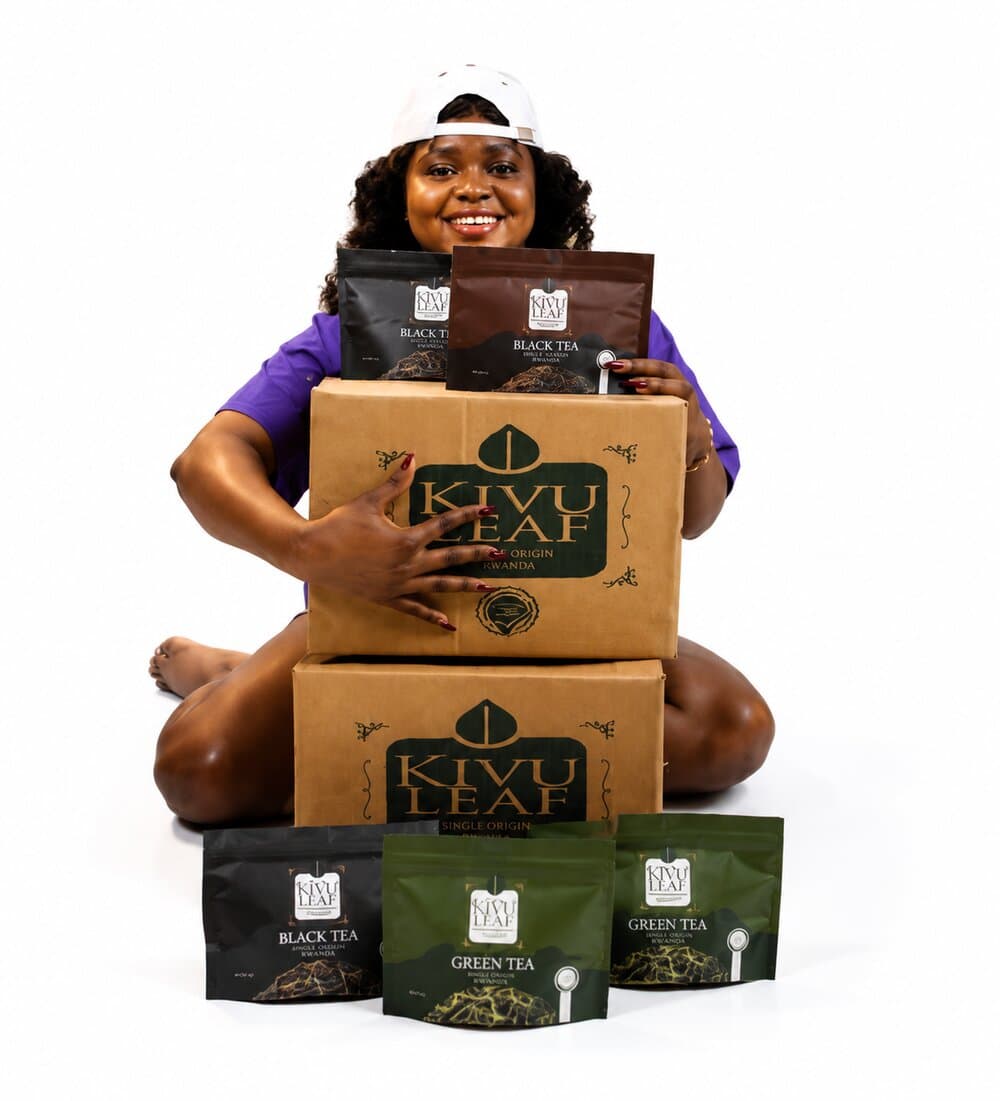 A KIVU Leaf distributor with cartons of KIVU Leaf Black Tea and Green Tea, single origin Rwanda
