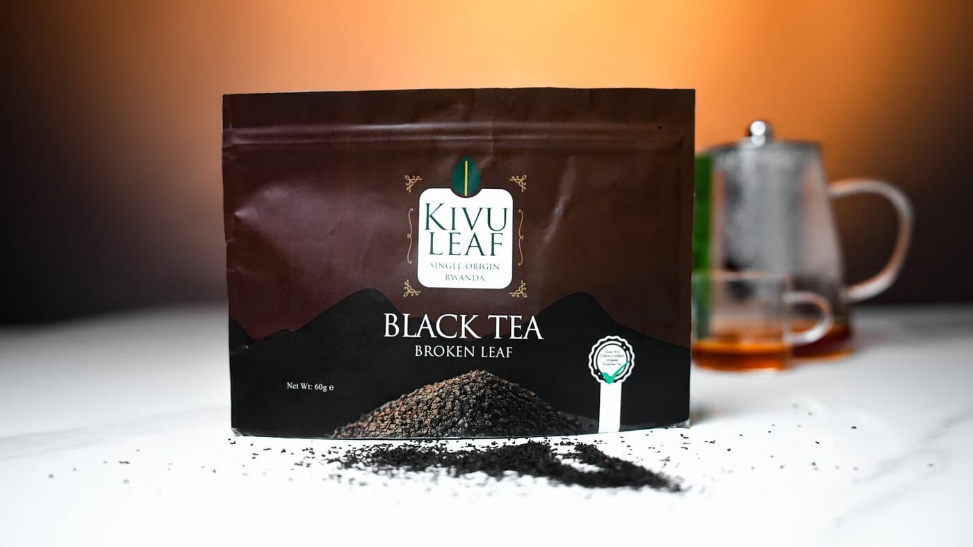KIVU Leaf Black Tea Broken Leaf pouch with loose leaf spilled beside a freshly brewed cup